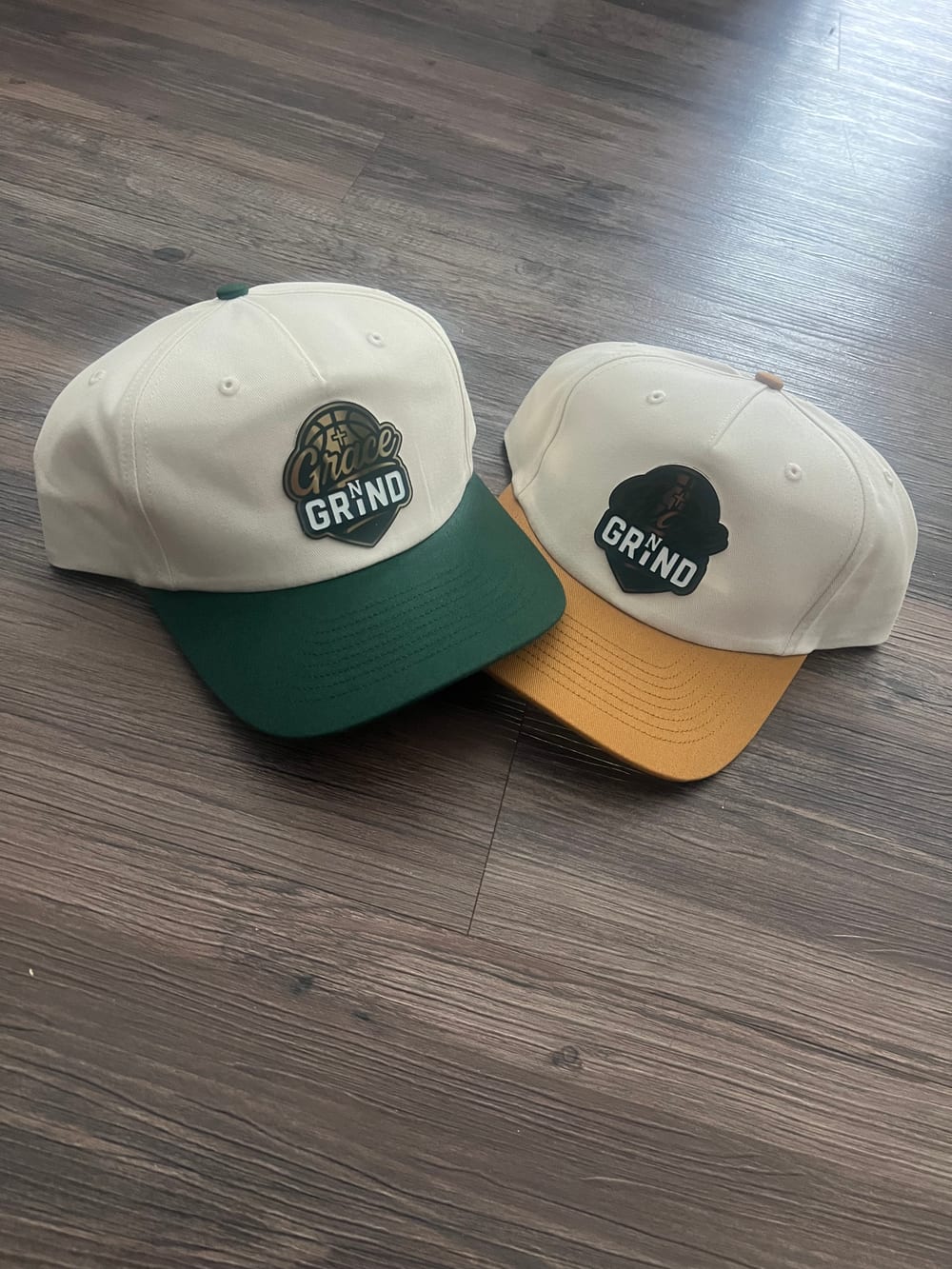 Two Grace N Grind hats on a gym floor