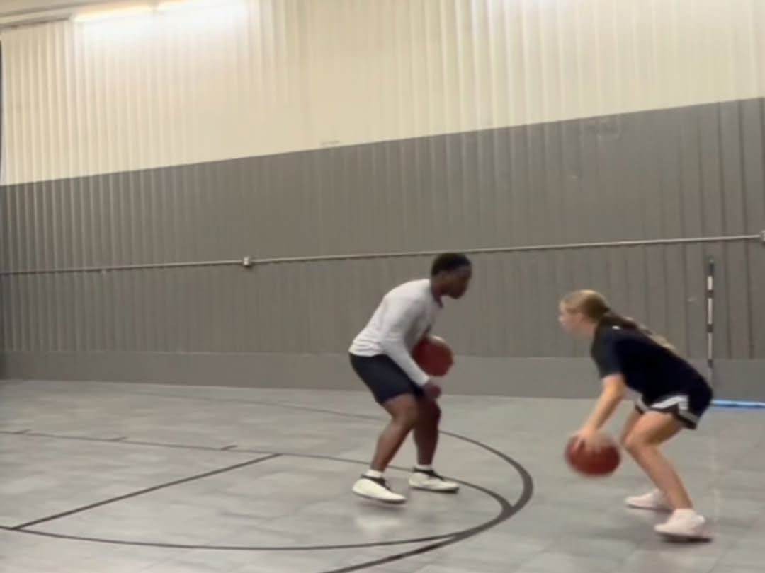 Coach Darrel guarding a Grace N Grind athlete in a one on one driving angle drill